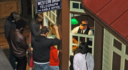 a group of people signing up for a self-guided tour at the Railroad Museum